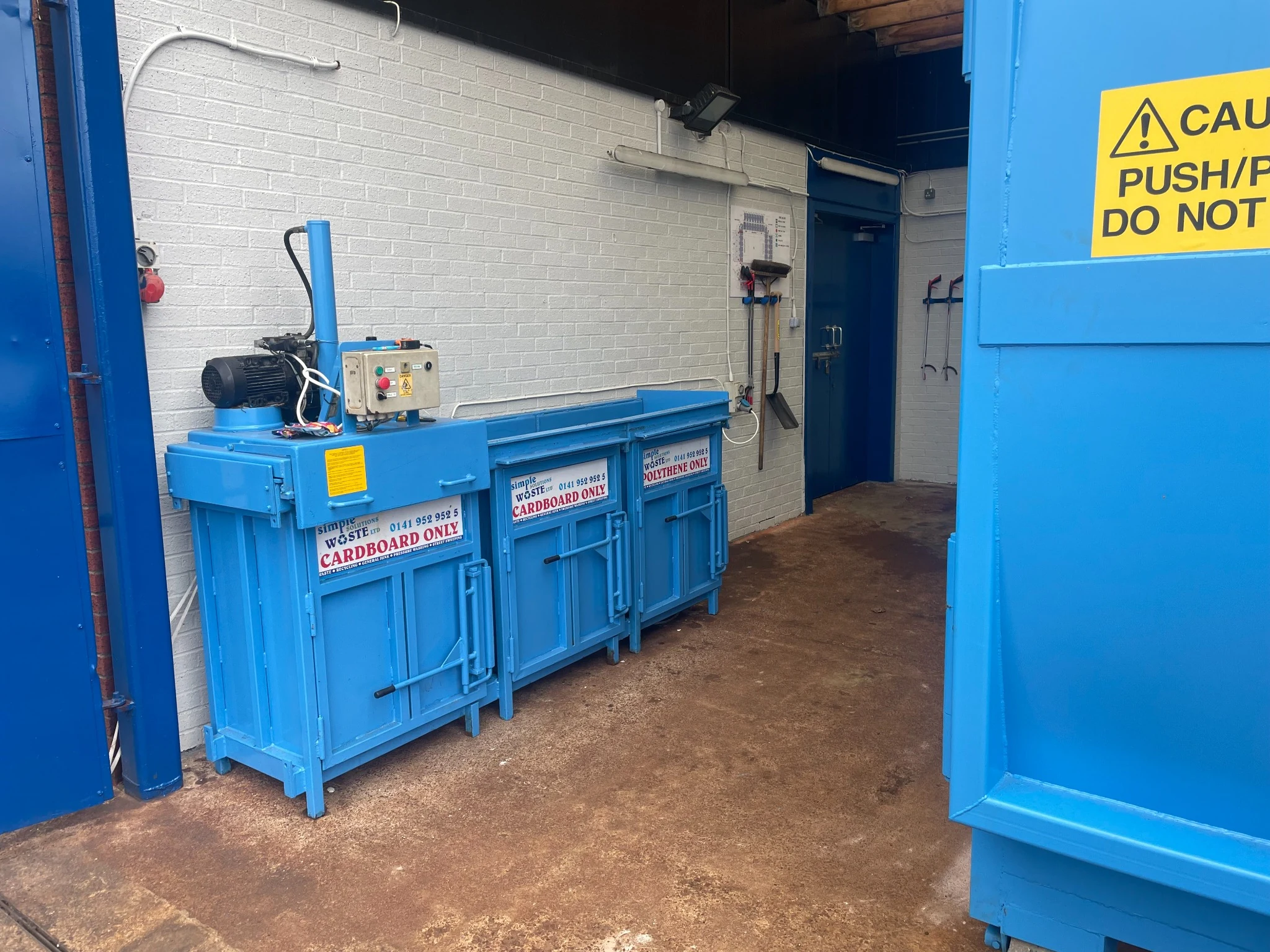 Blue SWS cardboard baler installed on a commercial site