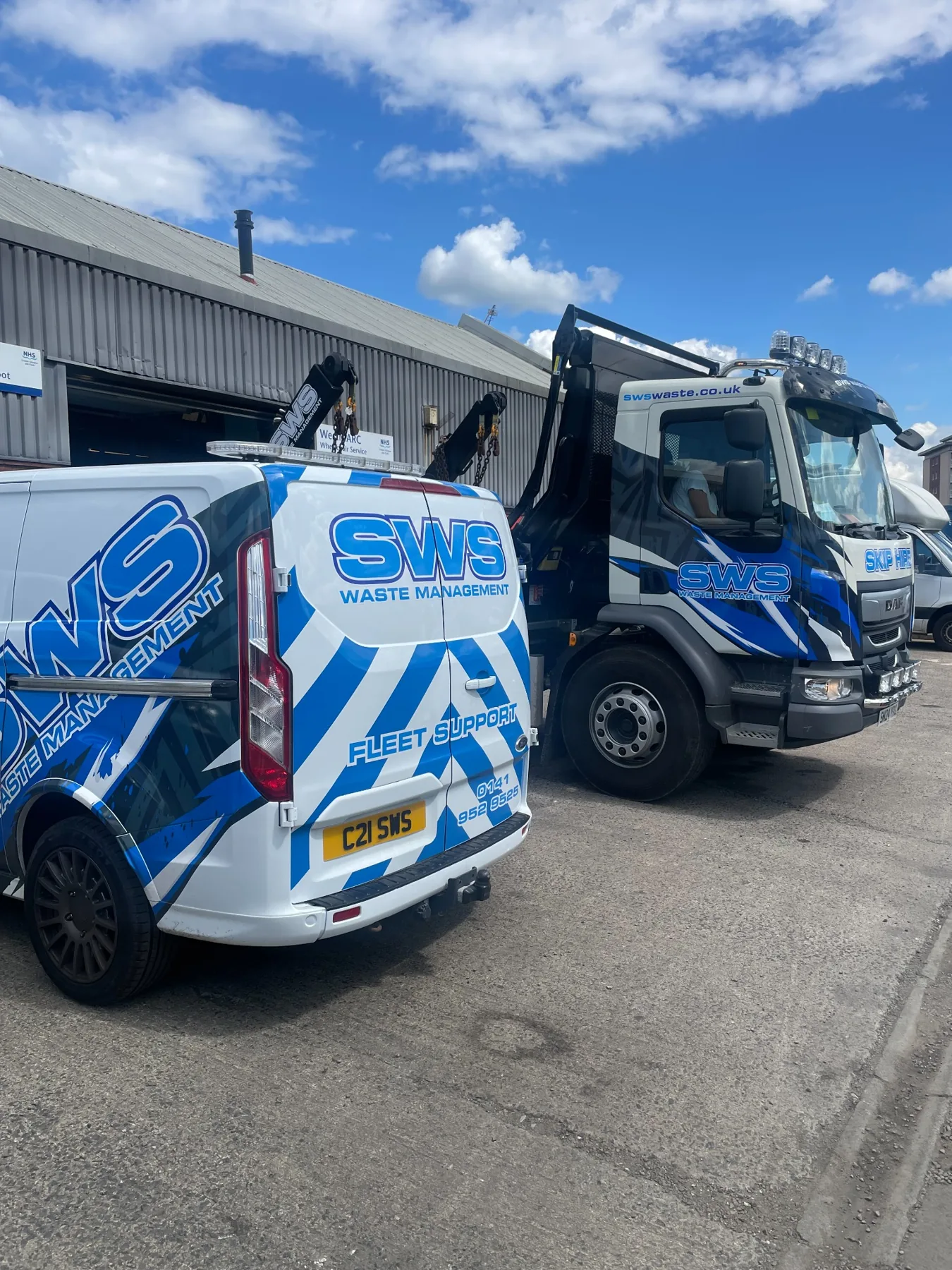 Genuine SWS fleet photograph showing branded vehicles at the company site.